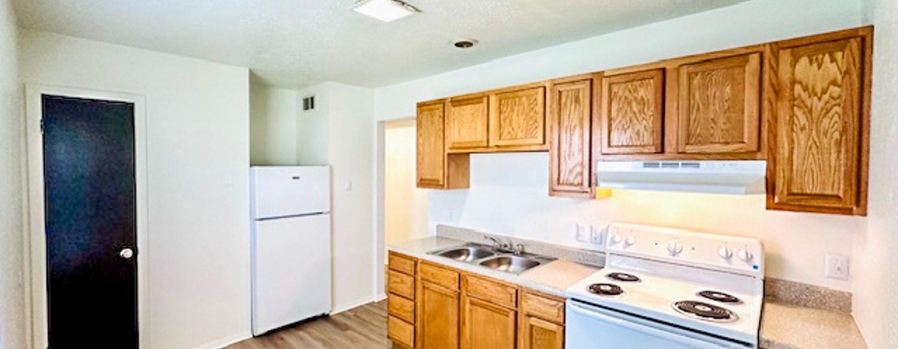 a kitchen with wooden cabinets