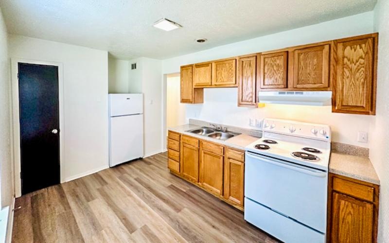 a kitchen with wooden cabinets