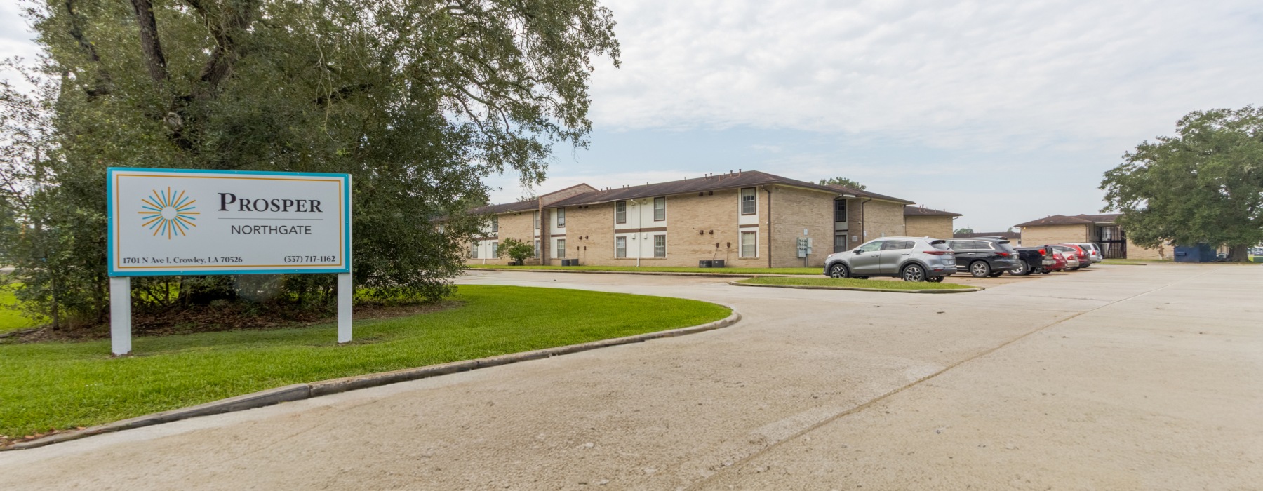 a sign in a grassy area