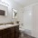 bathroom with brown cabinets and mirror