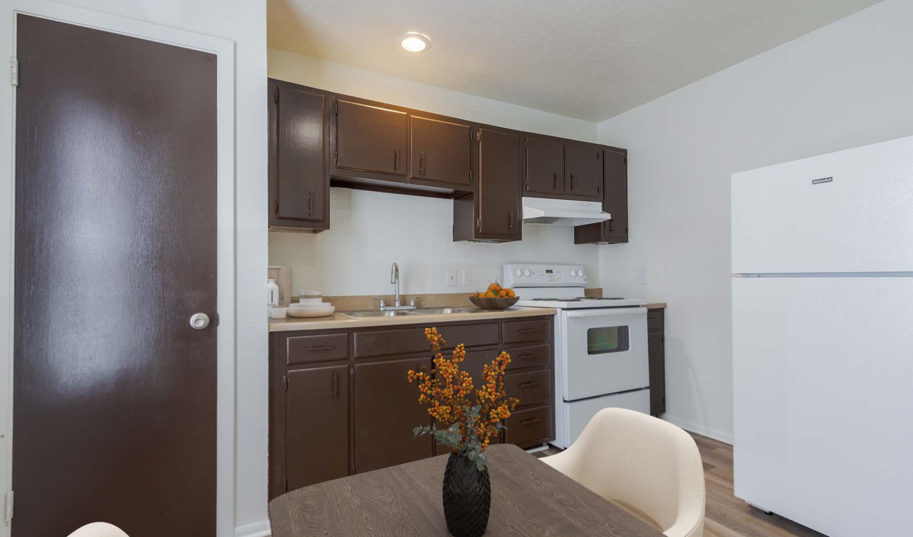 a kitchen with brown cabinets